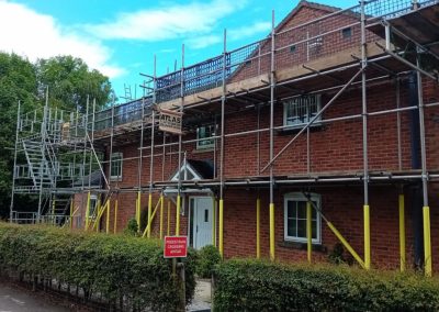 A detached property with scaffolding.