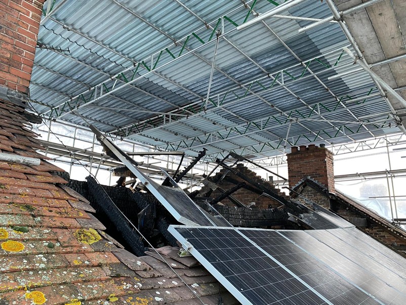 Another angle showing the erection of of a temporary roof scaffolding project erected over a fire-damaged property.